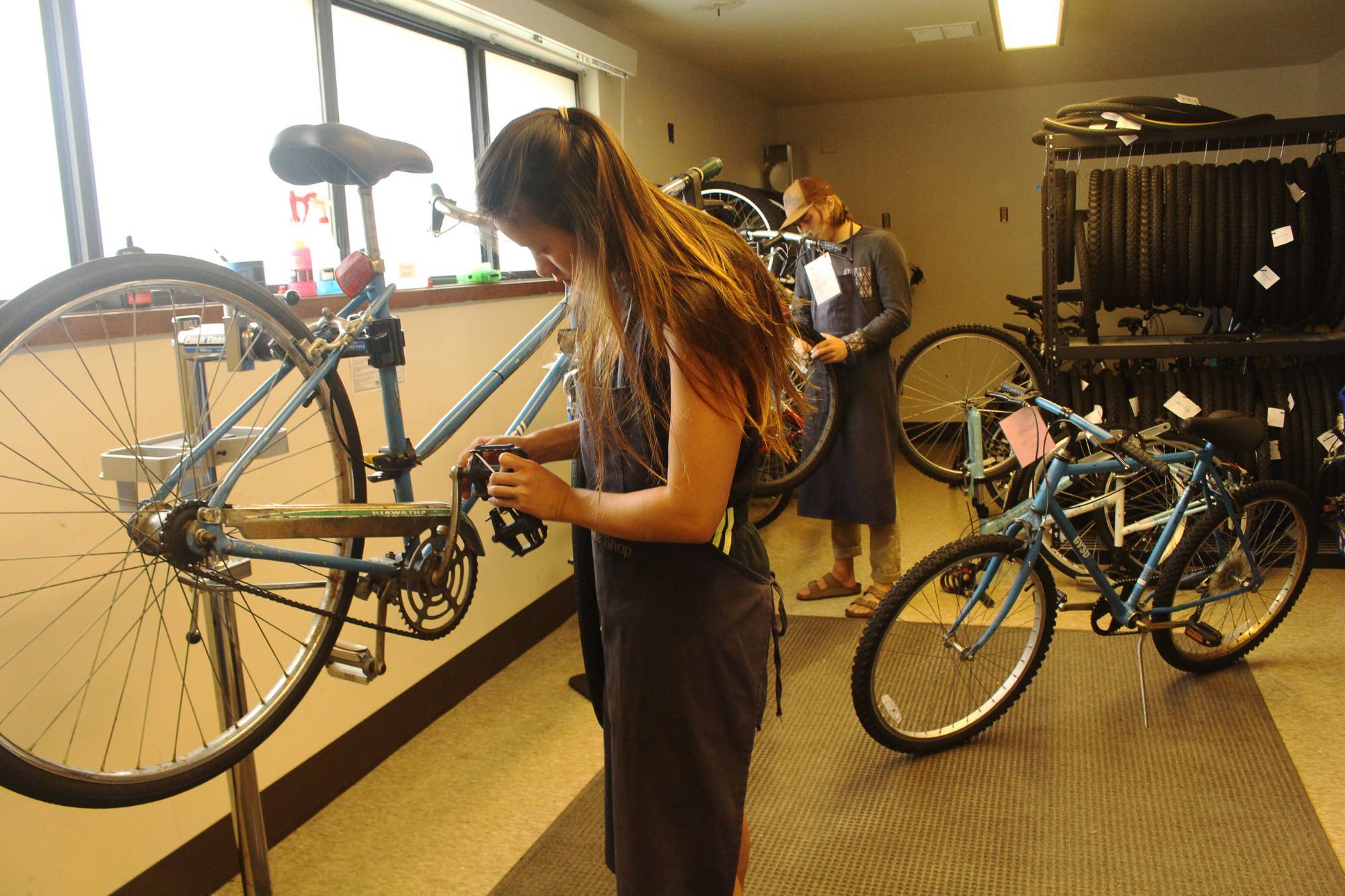 Two students fixing bicycles